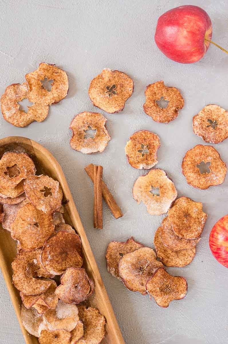 apple chips baked in the oven served on a wooden platter