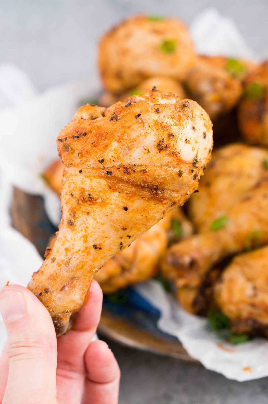 holding a roasted chicken leg