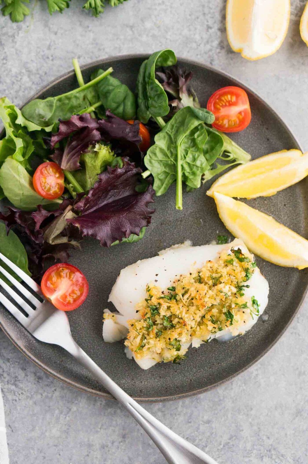 white fish with salad on a plate