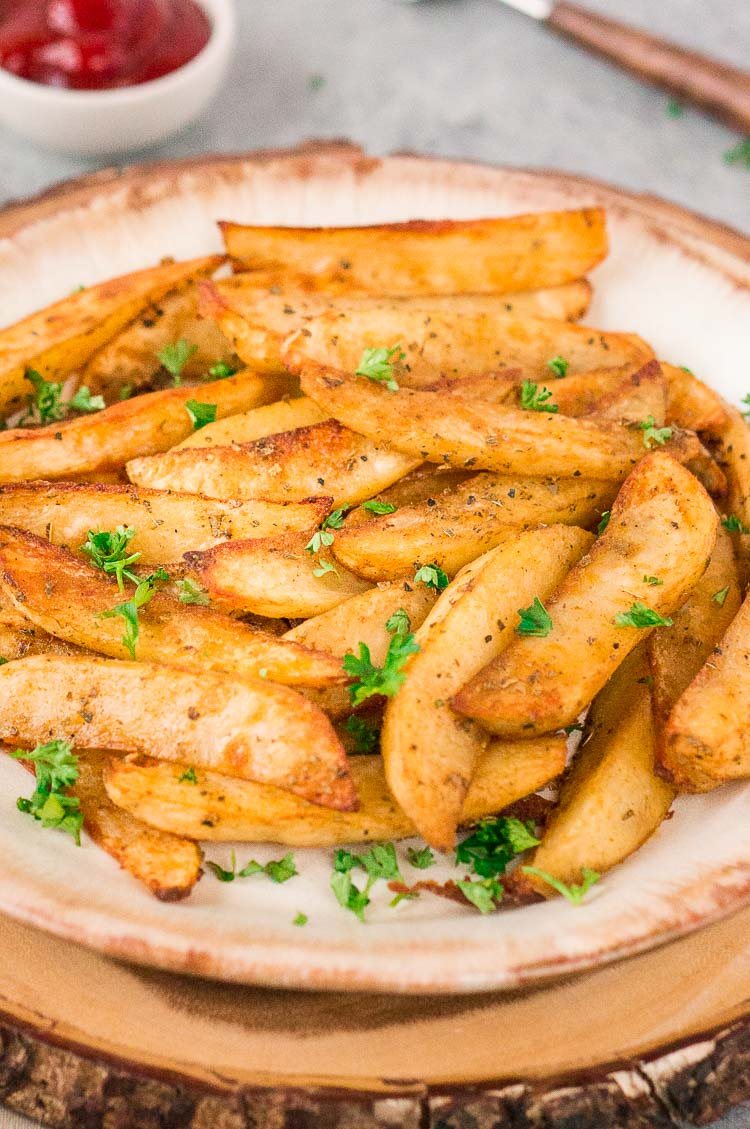 close up of baked potato wedges on a plate