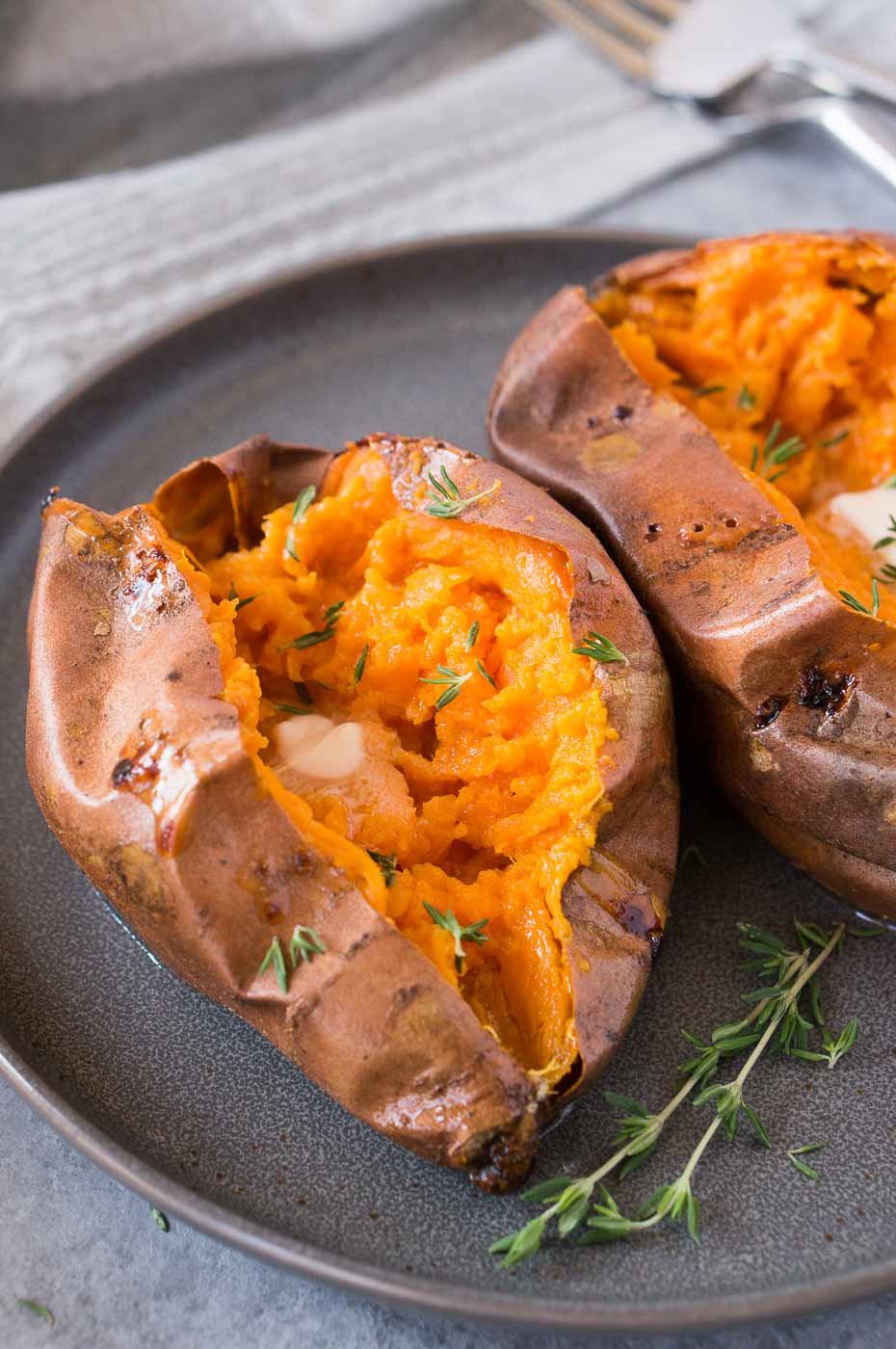 soft and tender sweet potatoes cut in half on a plate