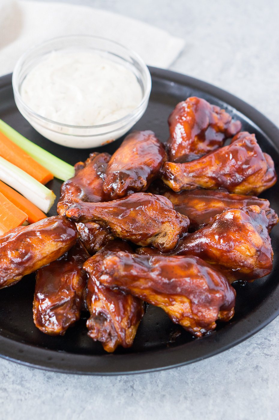 bbq chicken wings on a plate with ranch sauce