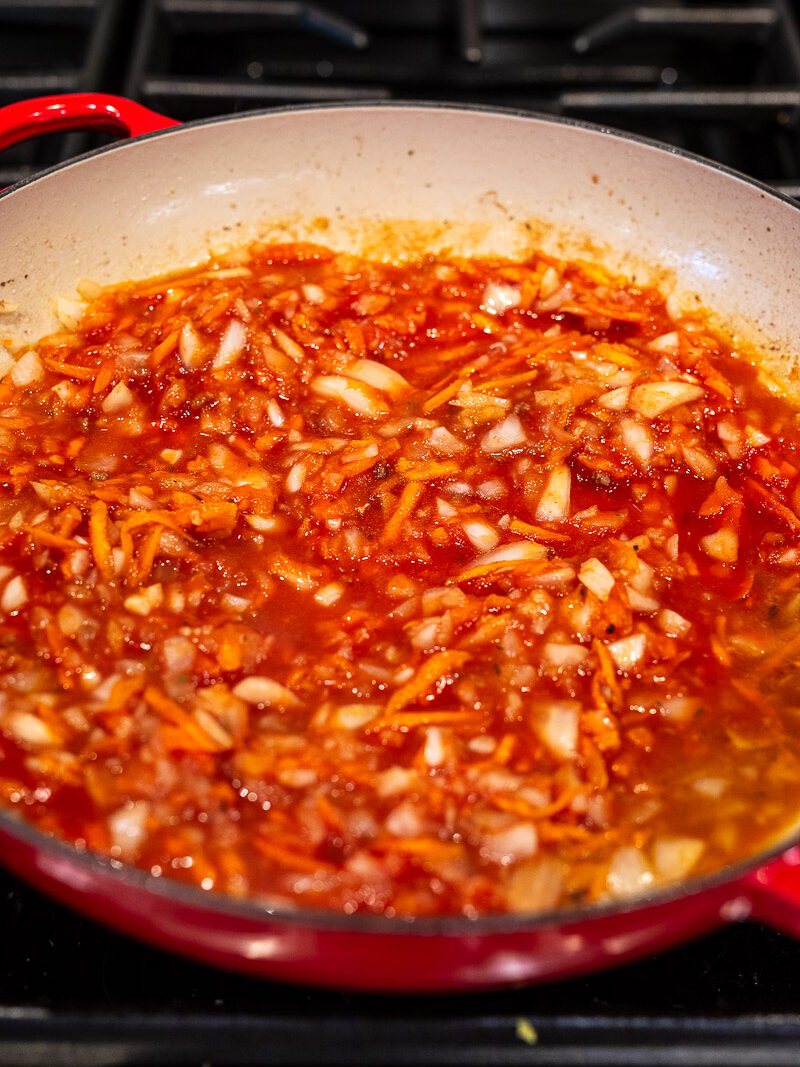 Simmer tomato sauce and chicken stock with the vegetables