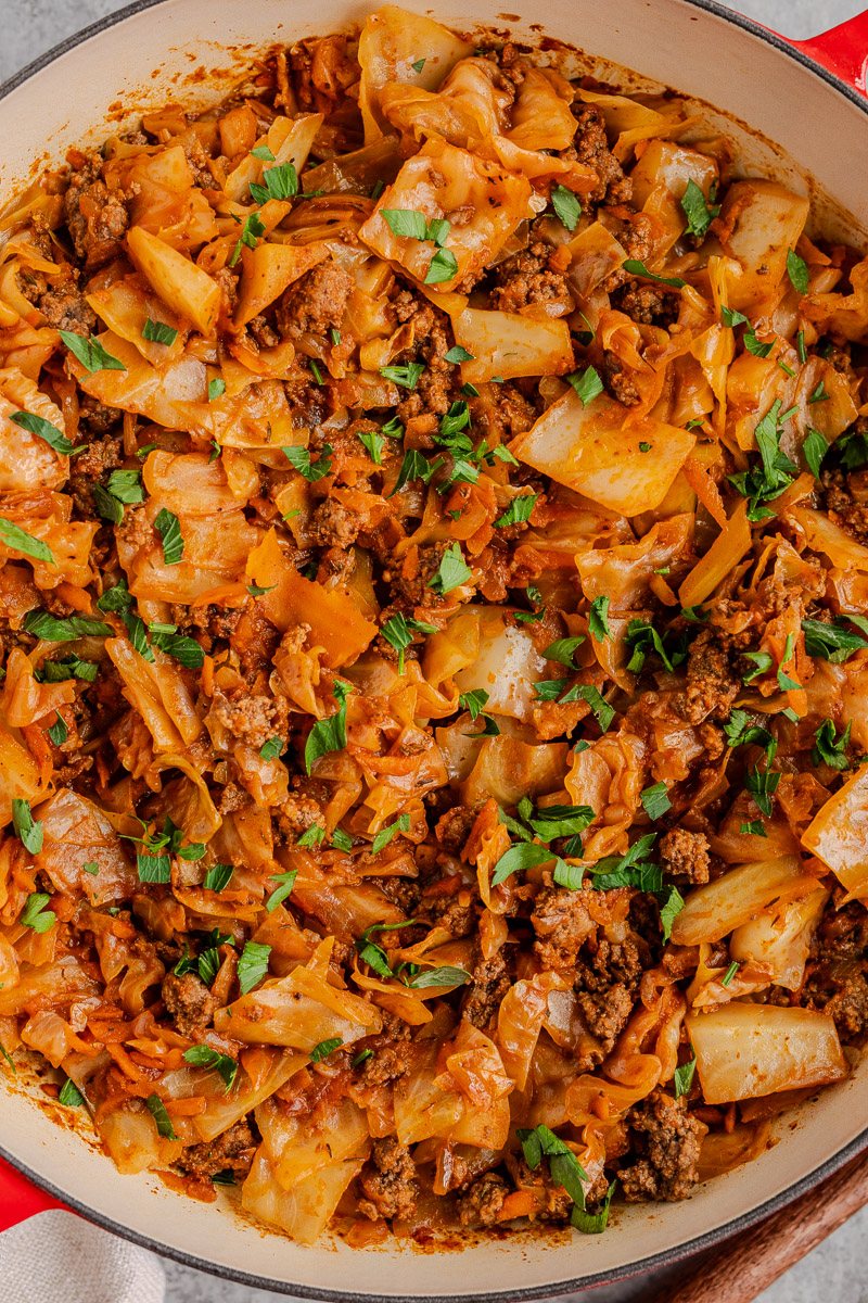sauted cabbage, vegetables and beef in a skillet.