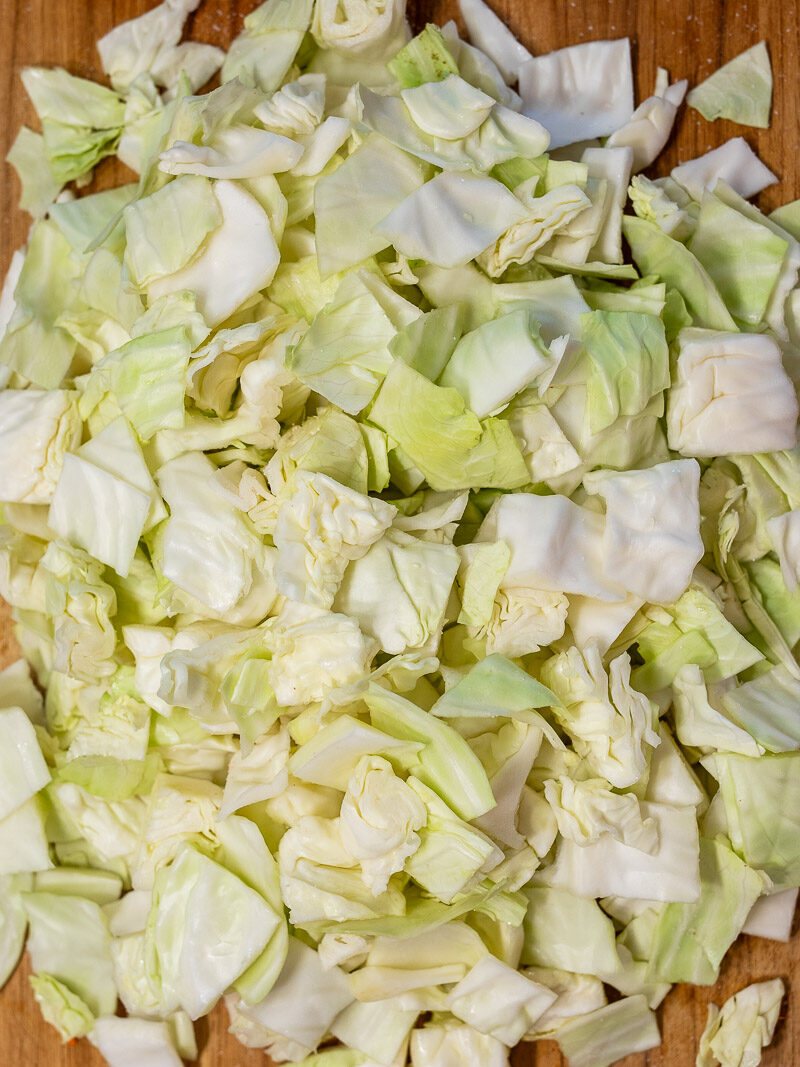 Massaging cabbage with salt on a cutting board
