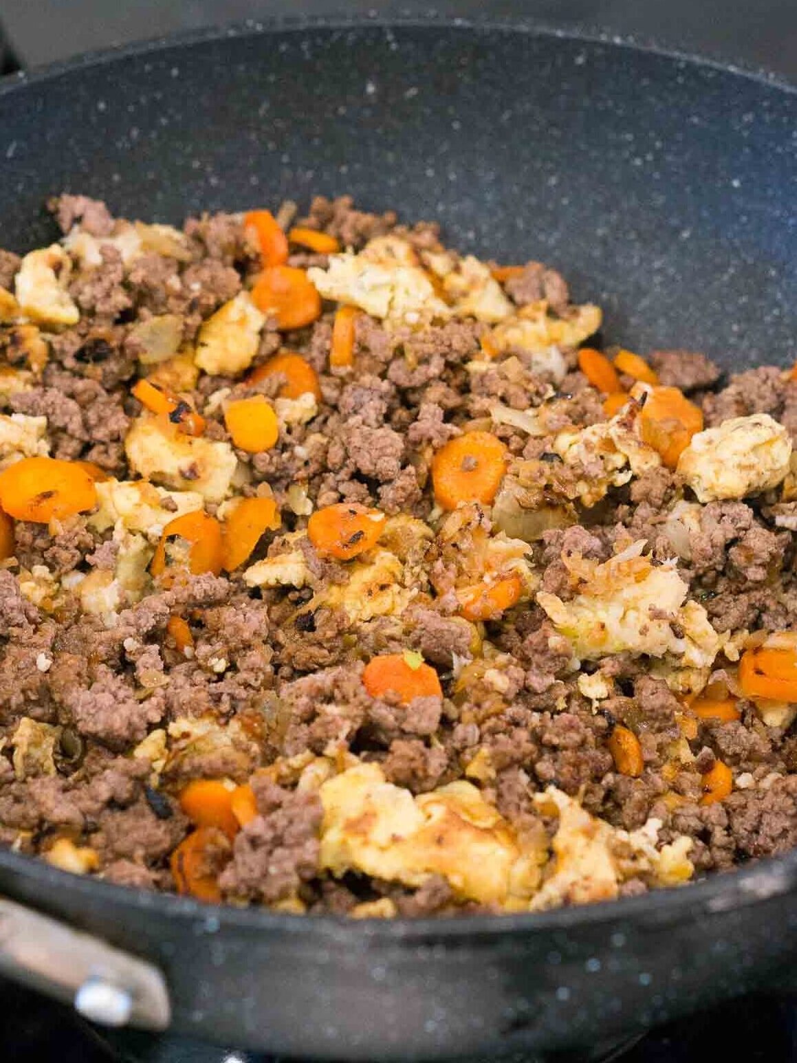 making healthy ground beef fried rice in a skillet