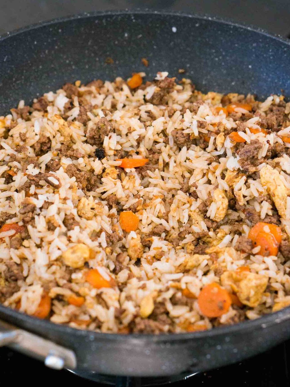 making healthy beef fried rice recipe with vegetables in a skillet