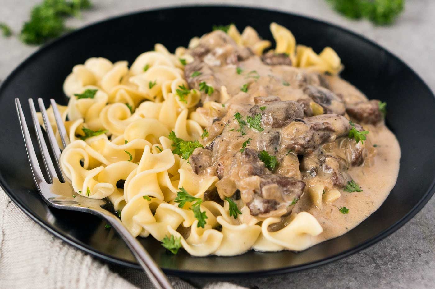 mushrooms and beef stroganoff over noodles