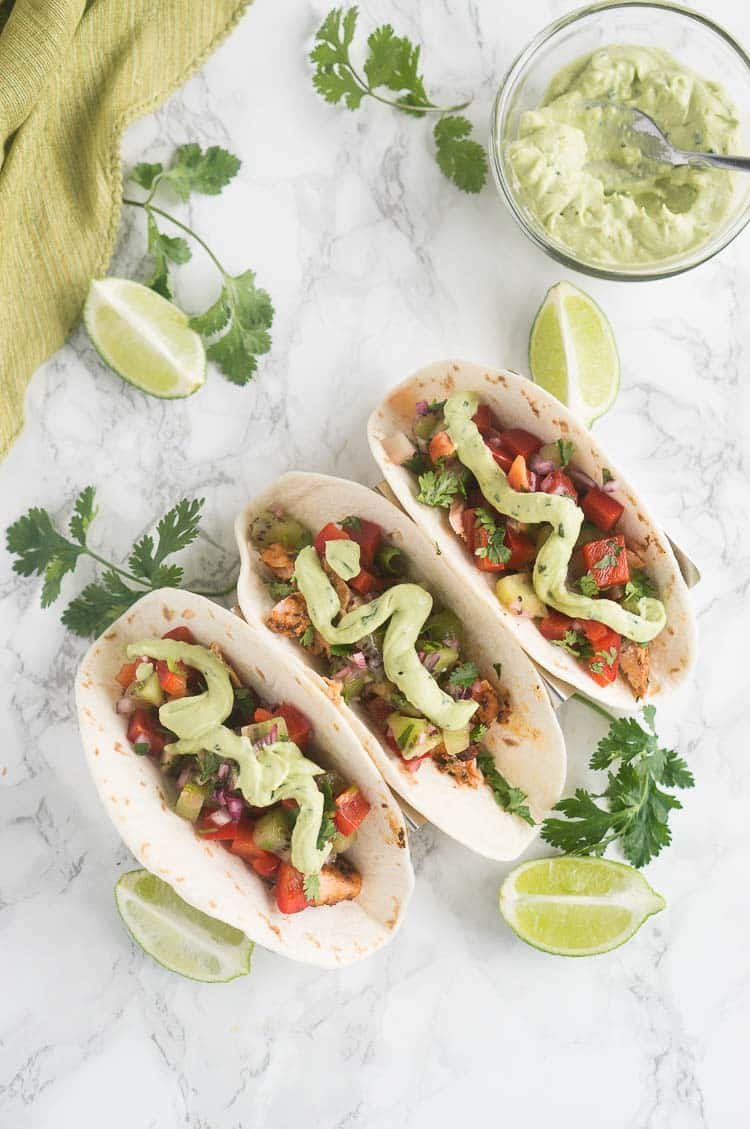 salmon tacos with salsa and avocado crema