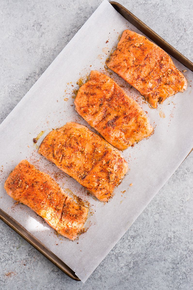 seasoned salmon on a baking sheet