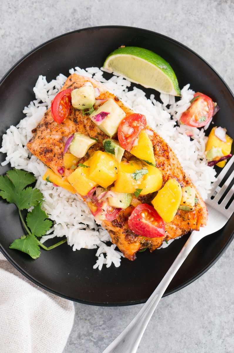 cooked salmon with mango avocado salsa on a plate