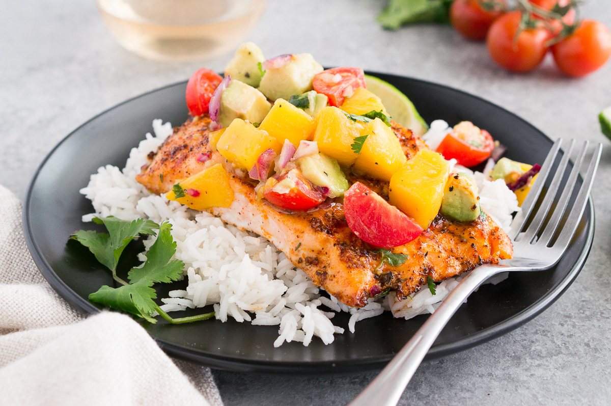 salmon with mango avocado salsa on a plate with rice