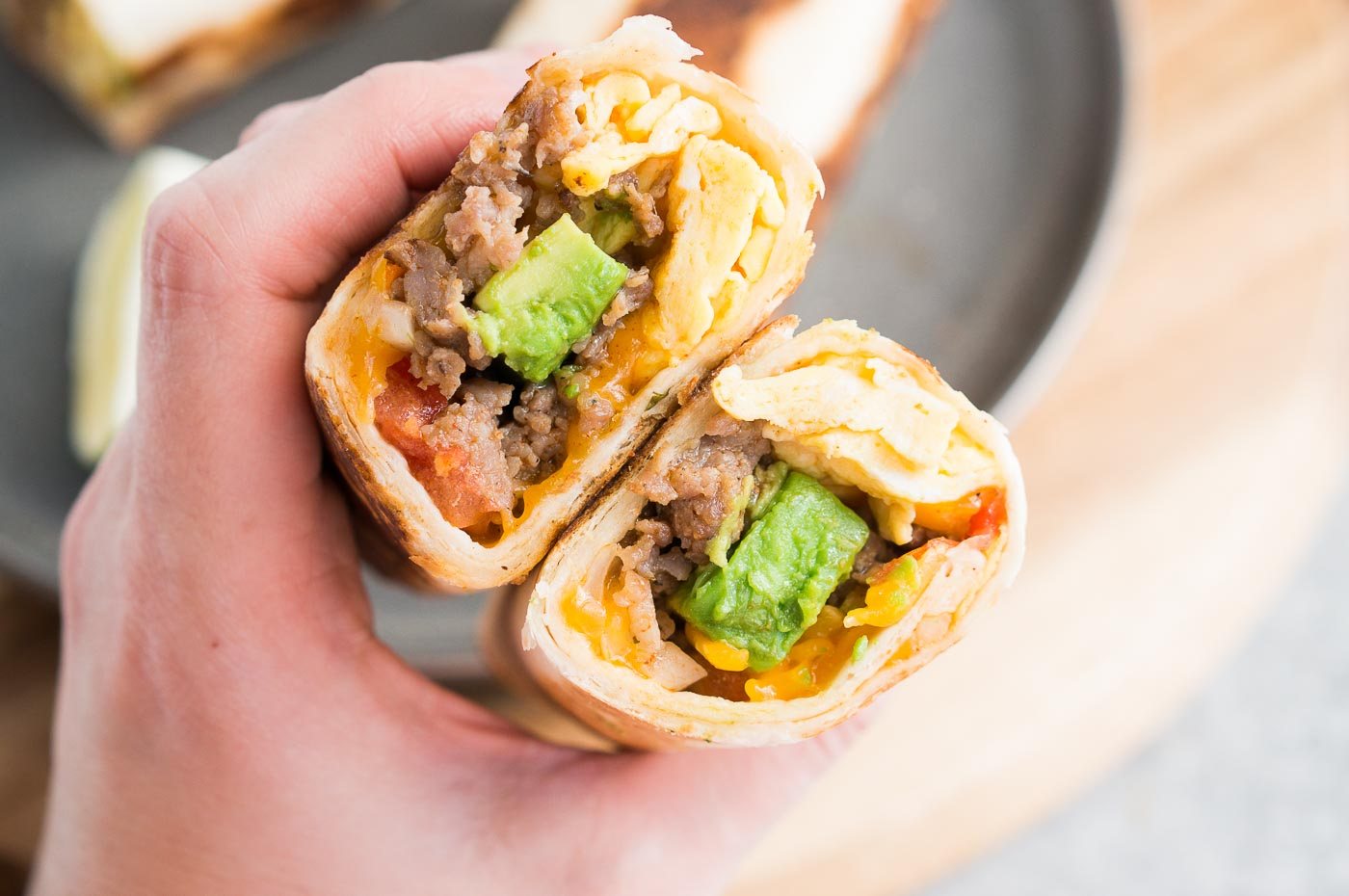 holding breakfast burritos