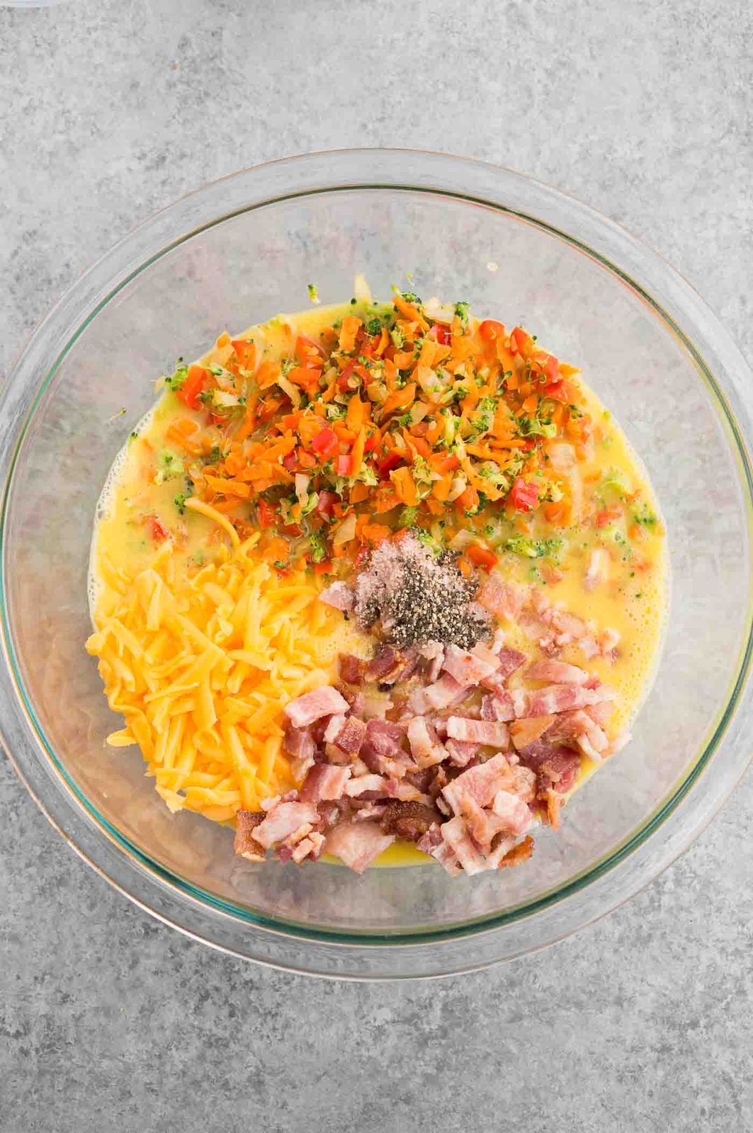 mixing eggs, vegetables and bacon