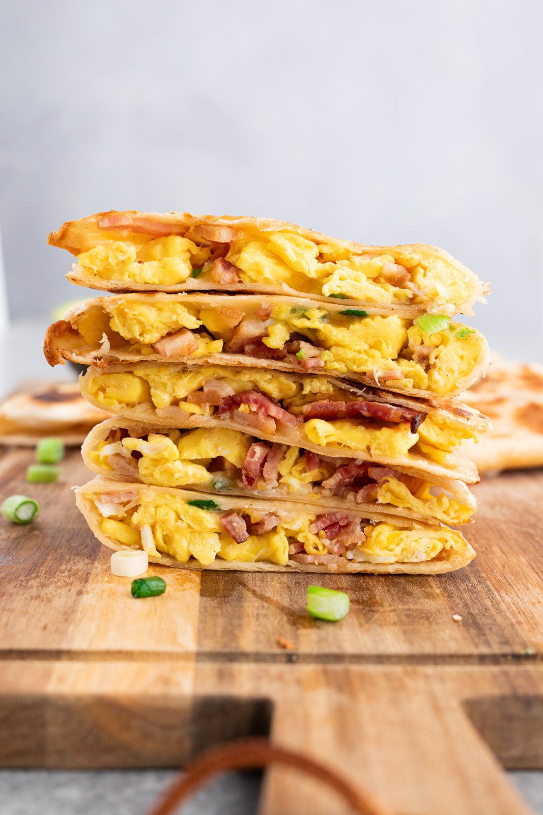 stacked breakfast quesadillas wedges on a cutting board