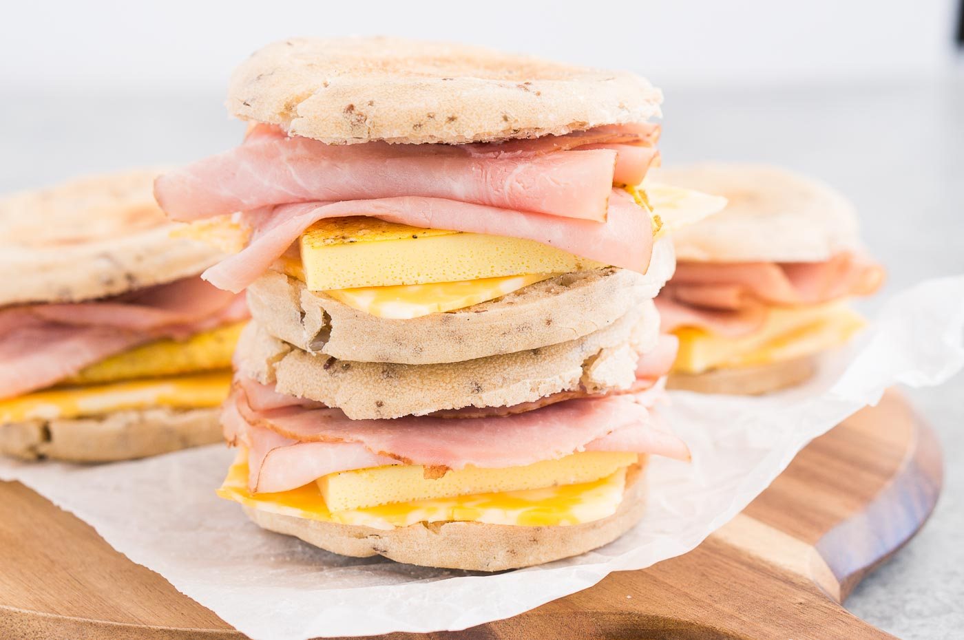 close up image of stacked breakfast sandwiches on a board