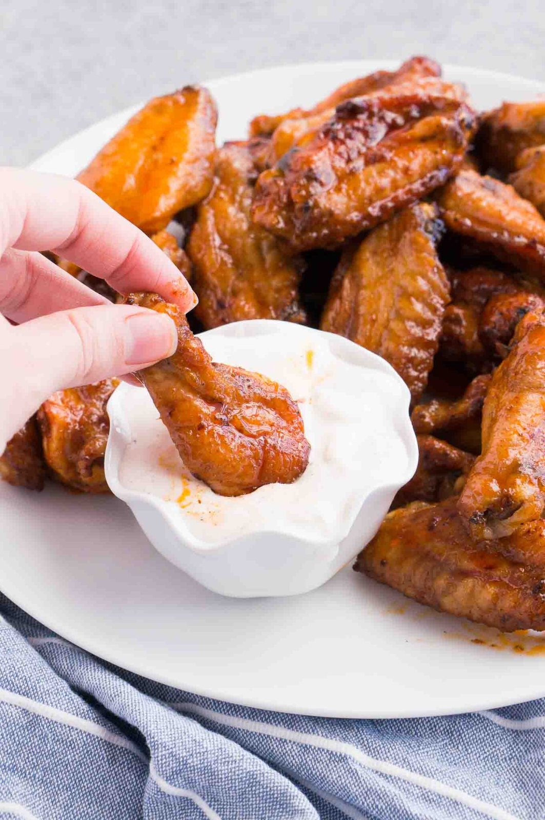 dipping a chicken wing in dipping sauce