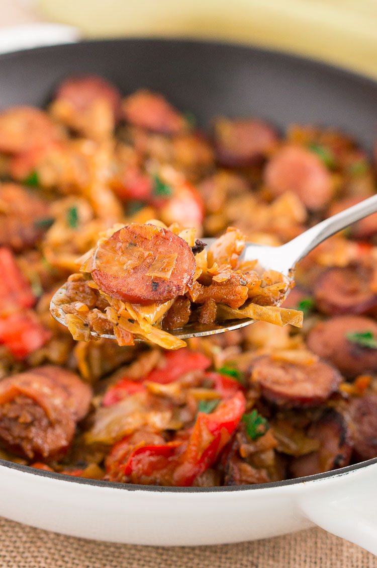 a spoonful of cooked Cabbage and Sausage