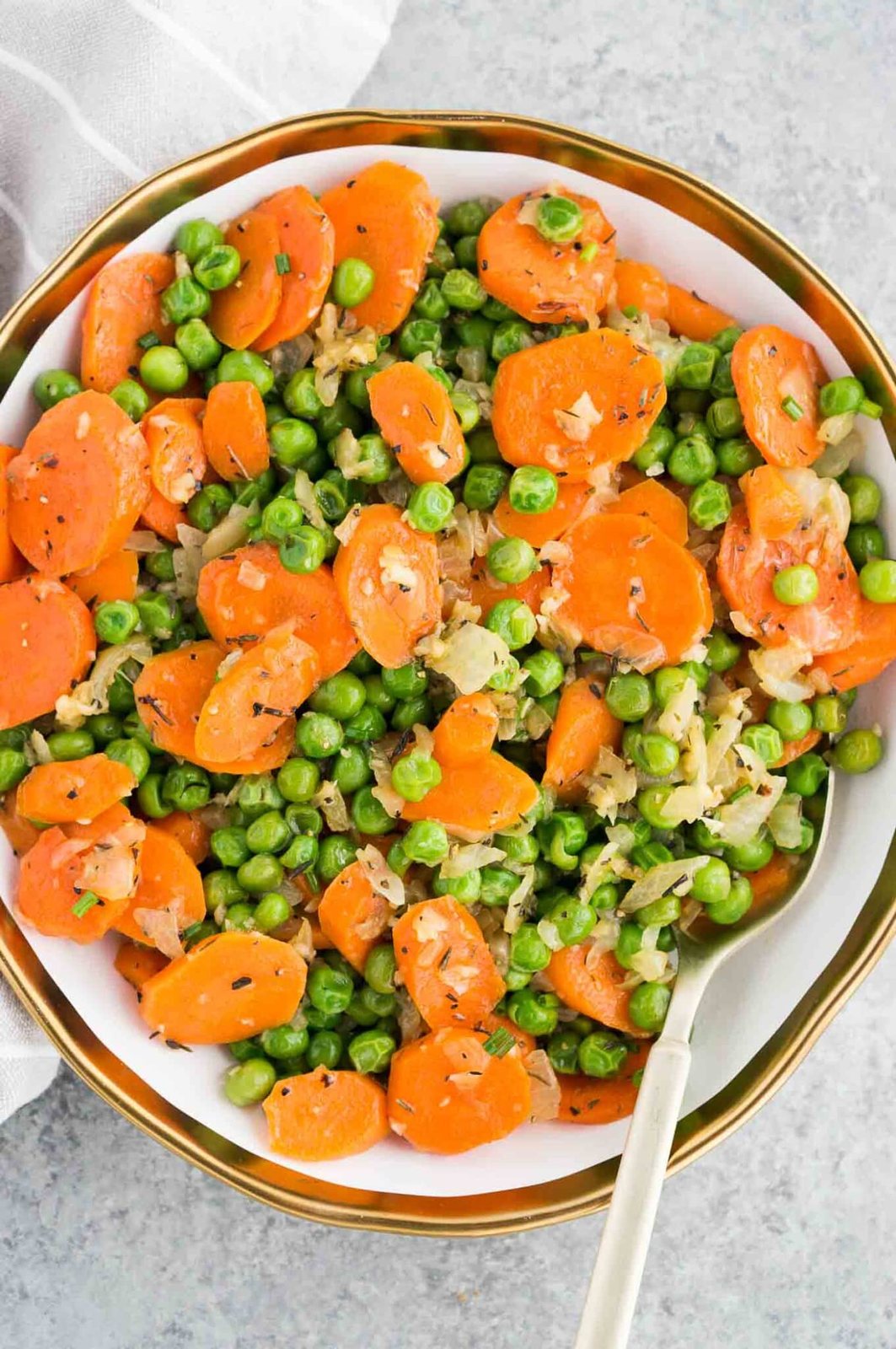 sauteed peas and carrots vegetable side dish in bowl