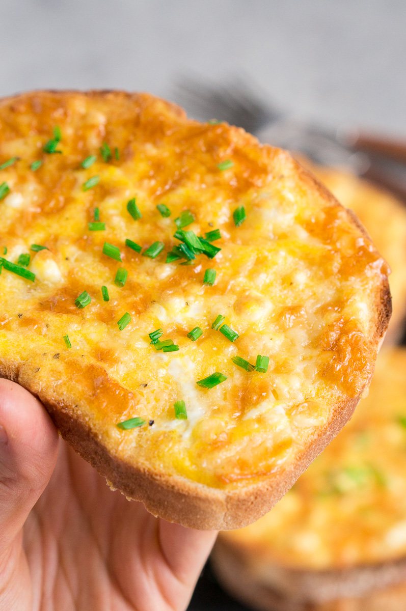 holding a cheesy egg toast