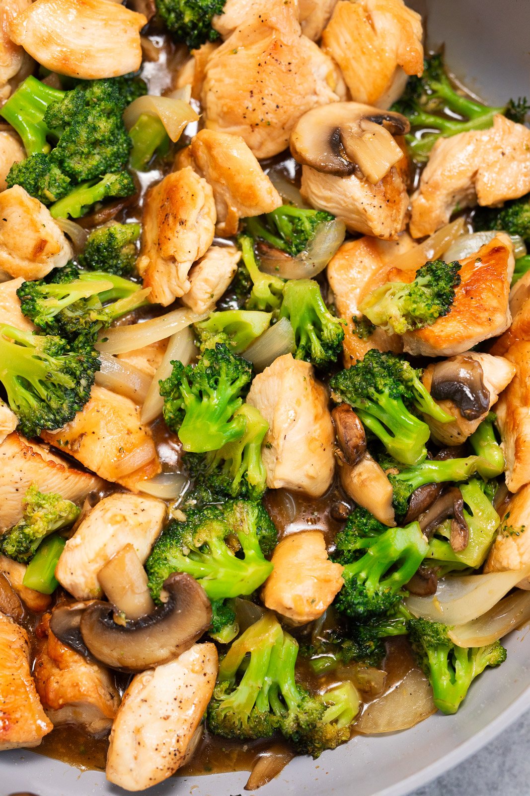 chicken, broccoli mushrooms cooked in a skillet
