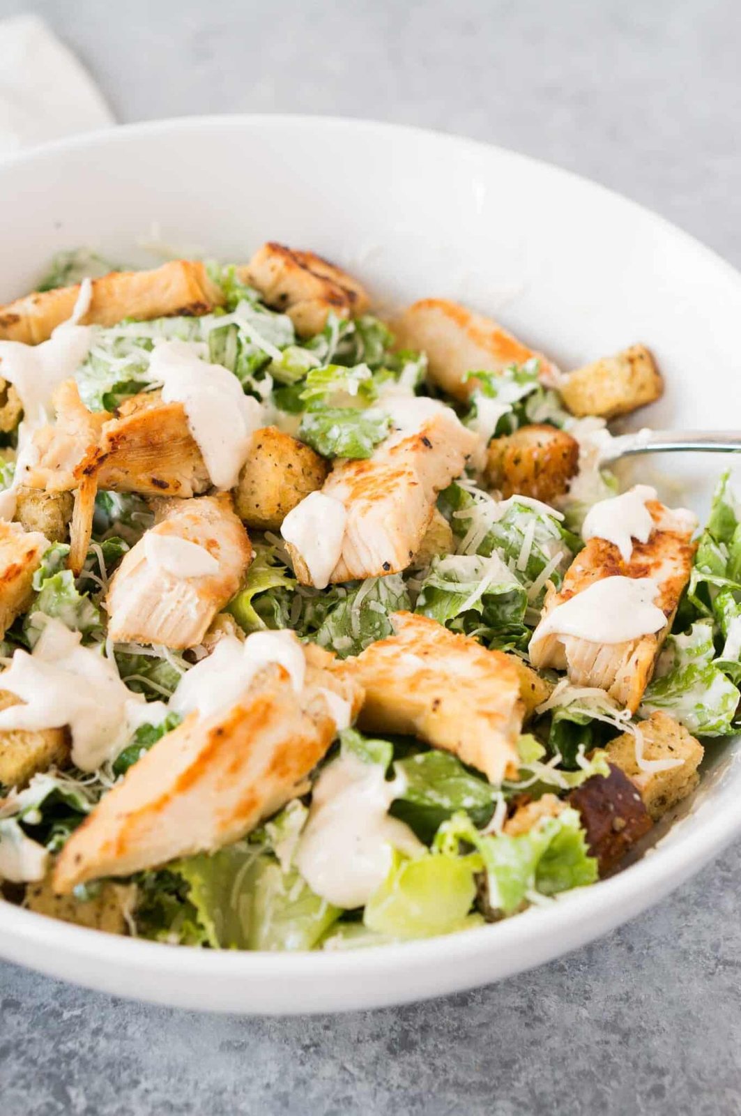 Caesar salad with grilled chicken in a bowl