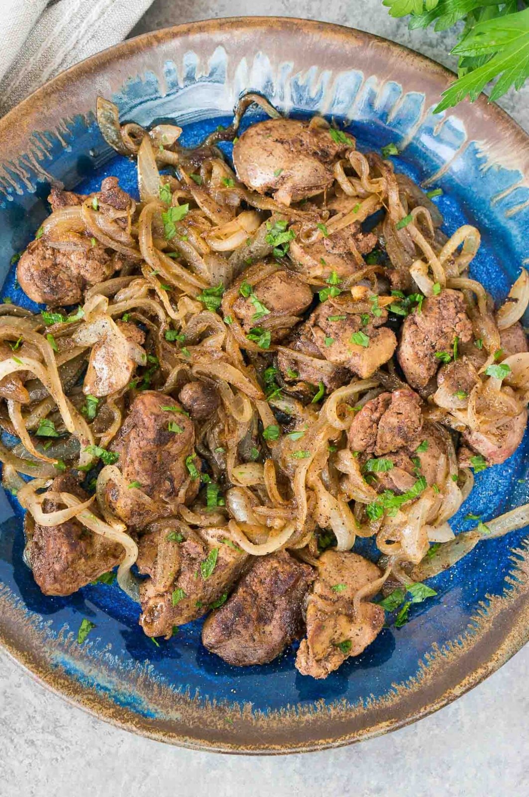 close up image from top of livers and onions on a plate