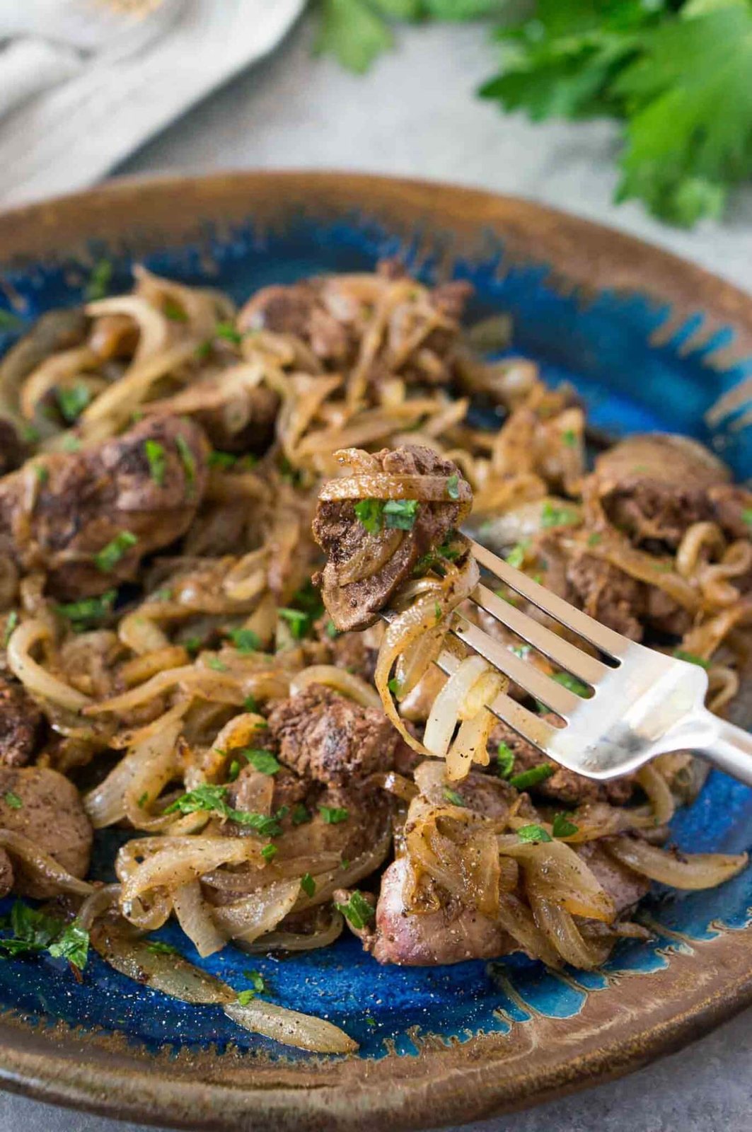 close up image of livers and caramelized onions on a plate