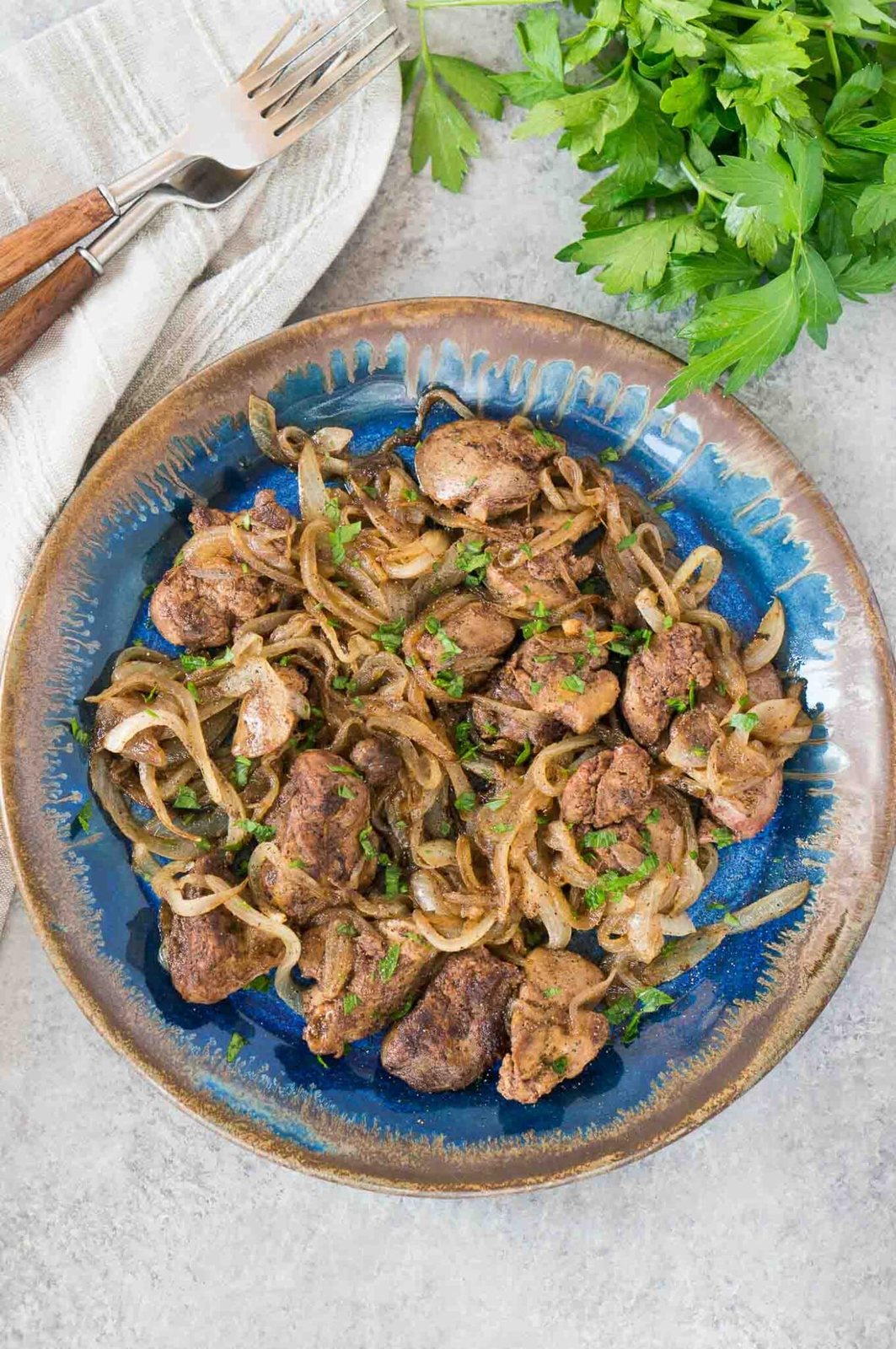 delicious chicken livers and onions served on a plate