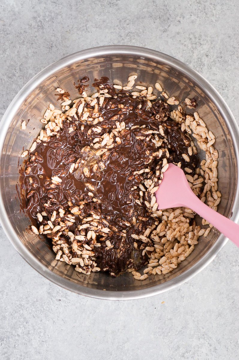 mixing rice puffs, peanut butter and chocolate