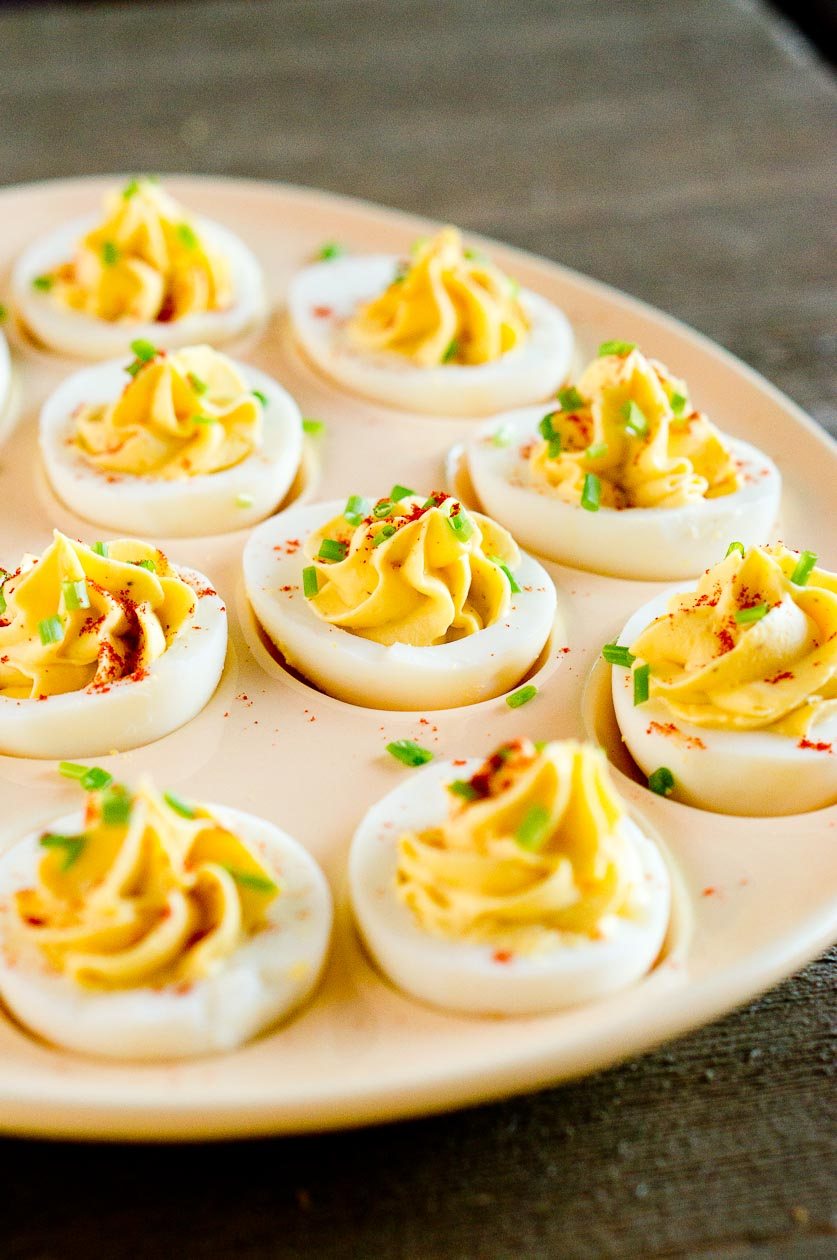 Egg appetizer on a plate garnished with fresh herbs
