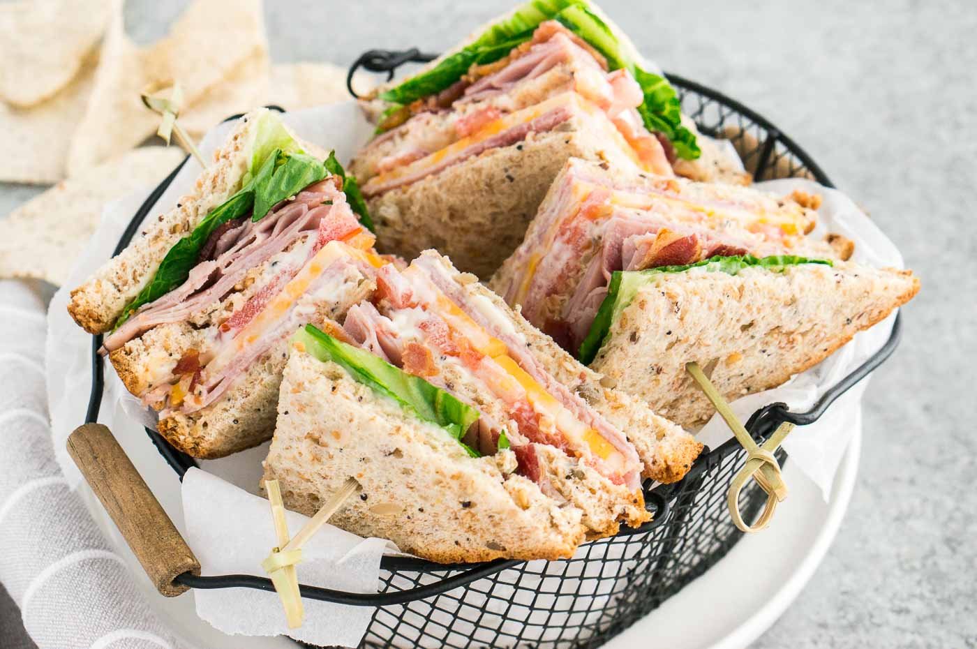 close up image of the best clubhouse sandwiches in a basket