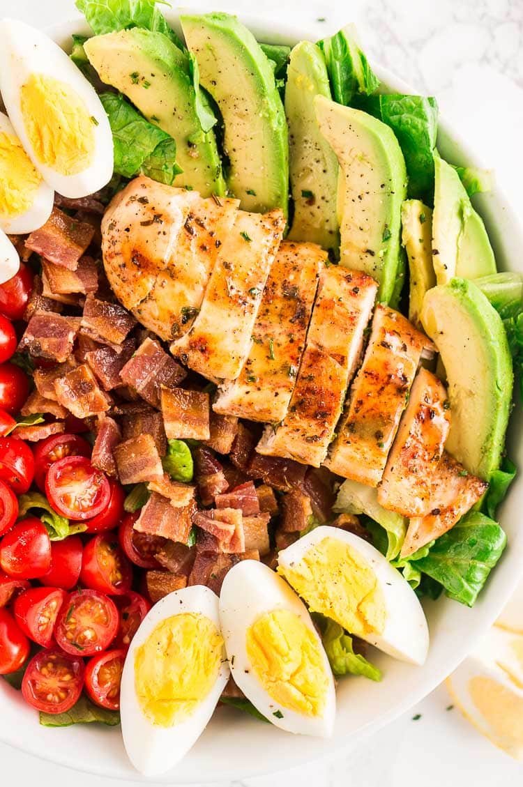 close up image of chicken cobb salad served in a large bowl