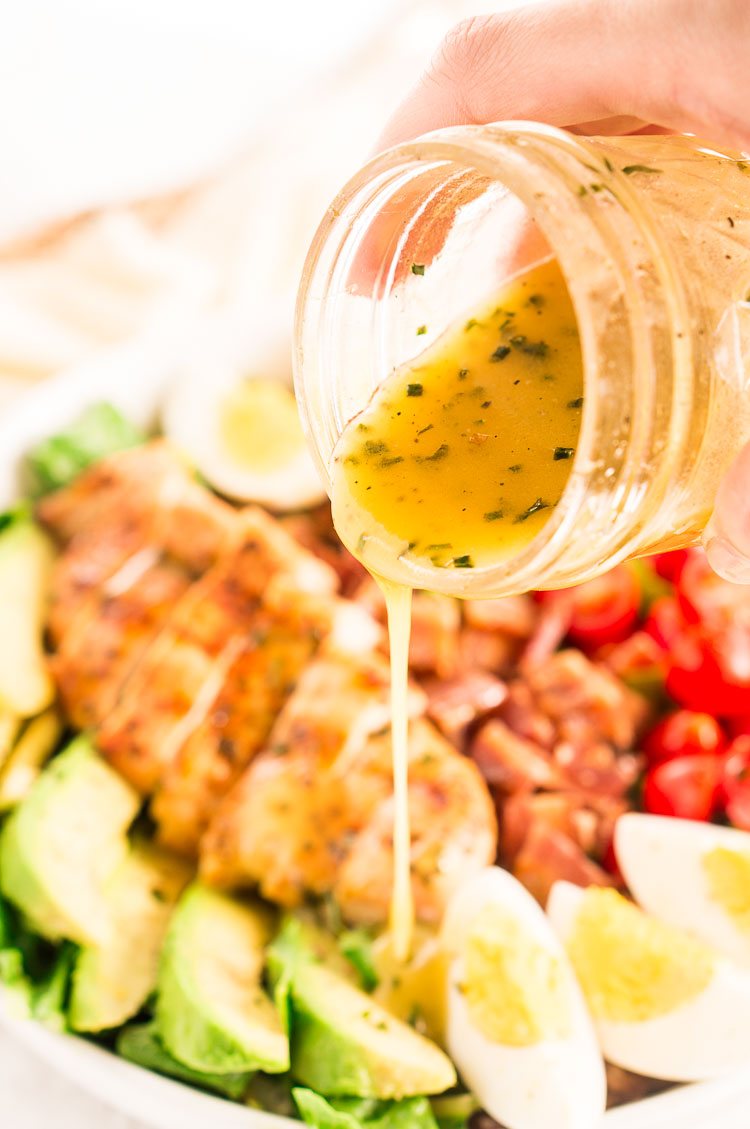 Pouring dressing over salad