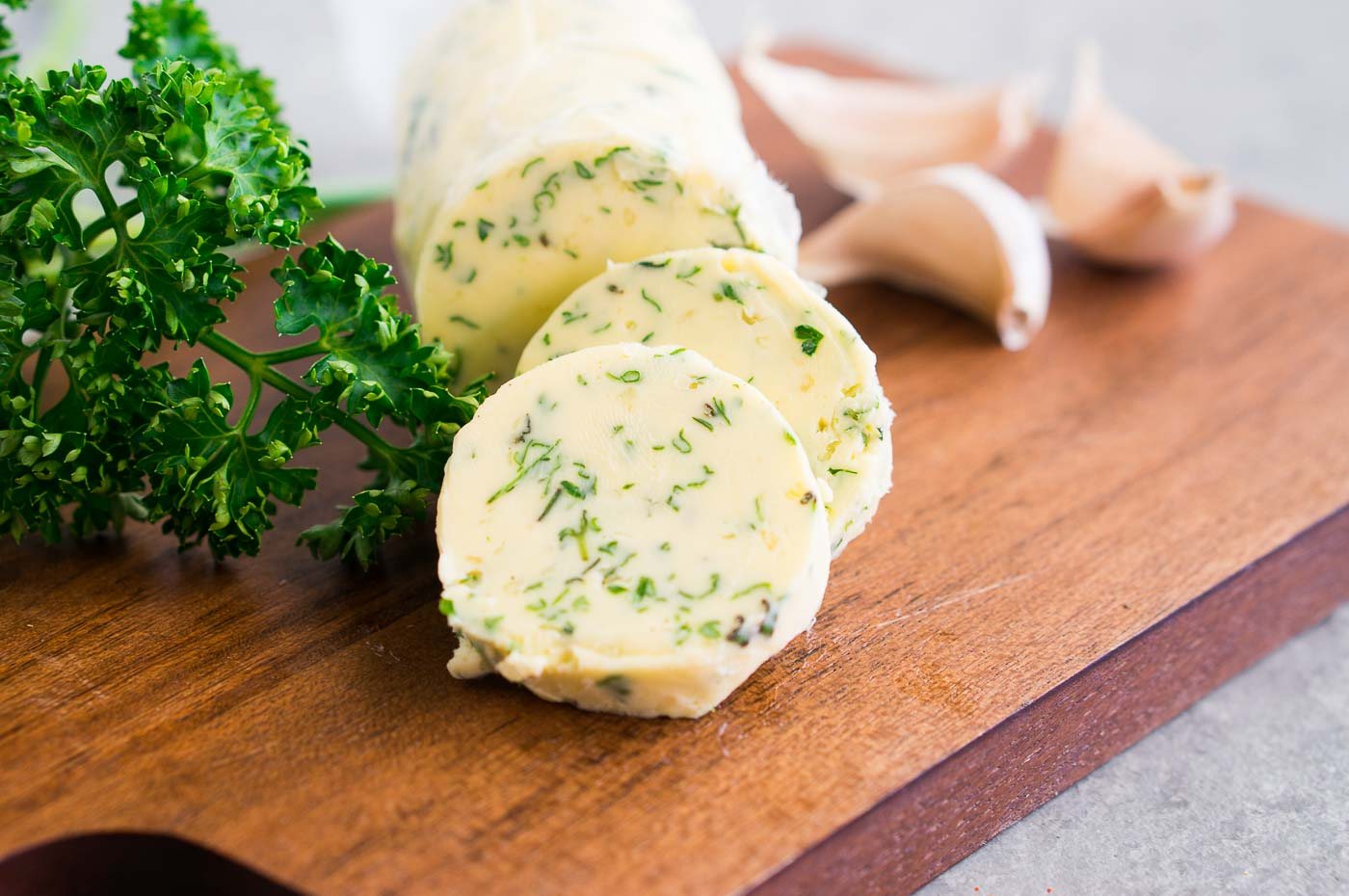 close up image of garlic herb butter wrapped in parchment paper