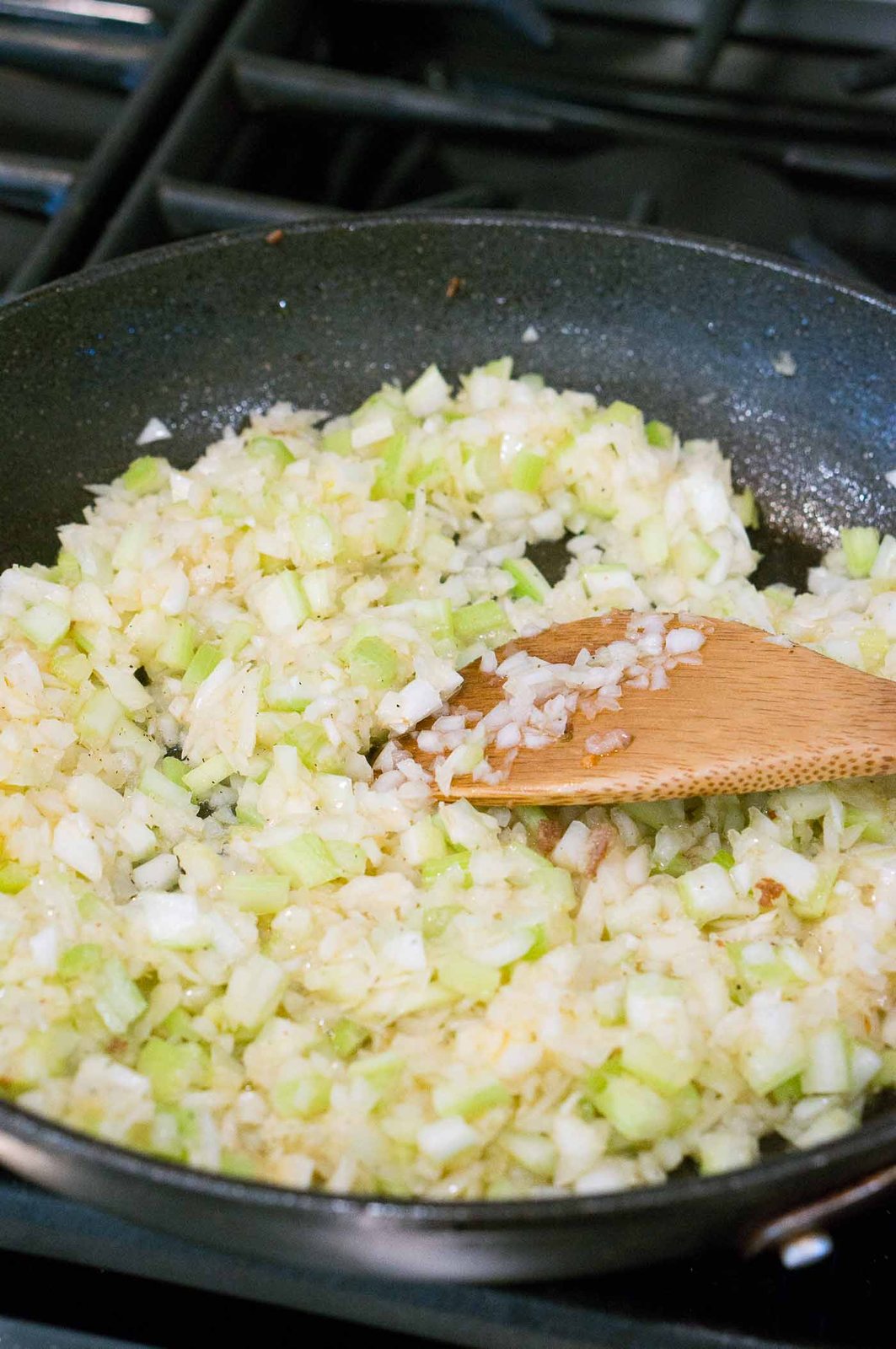 sauteing onions and celery in a skillet
