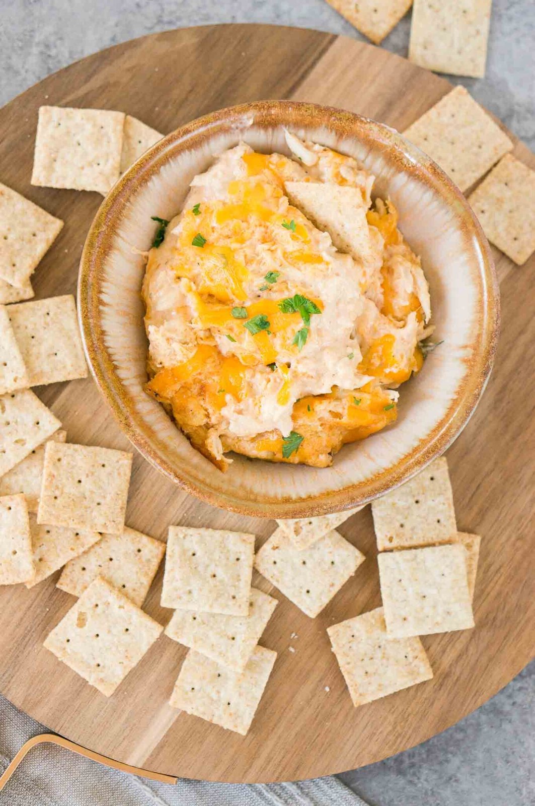image from top of hot crab dip in a bowl served with crackers