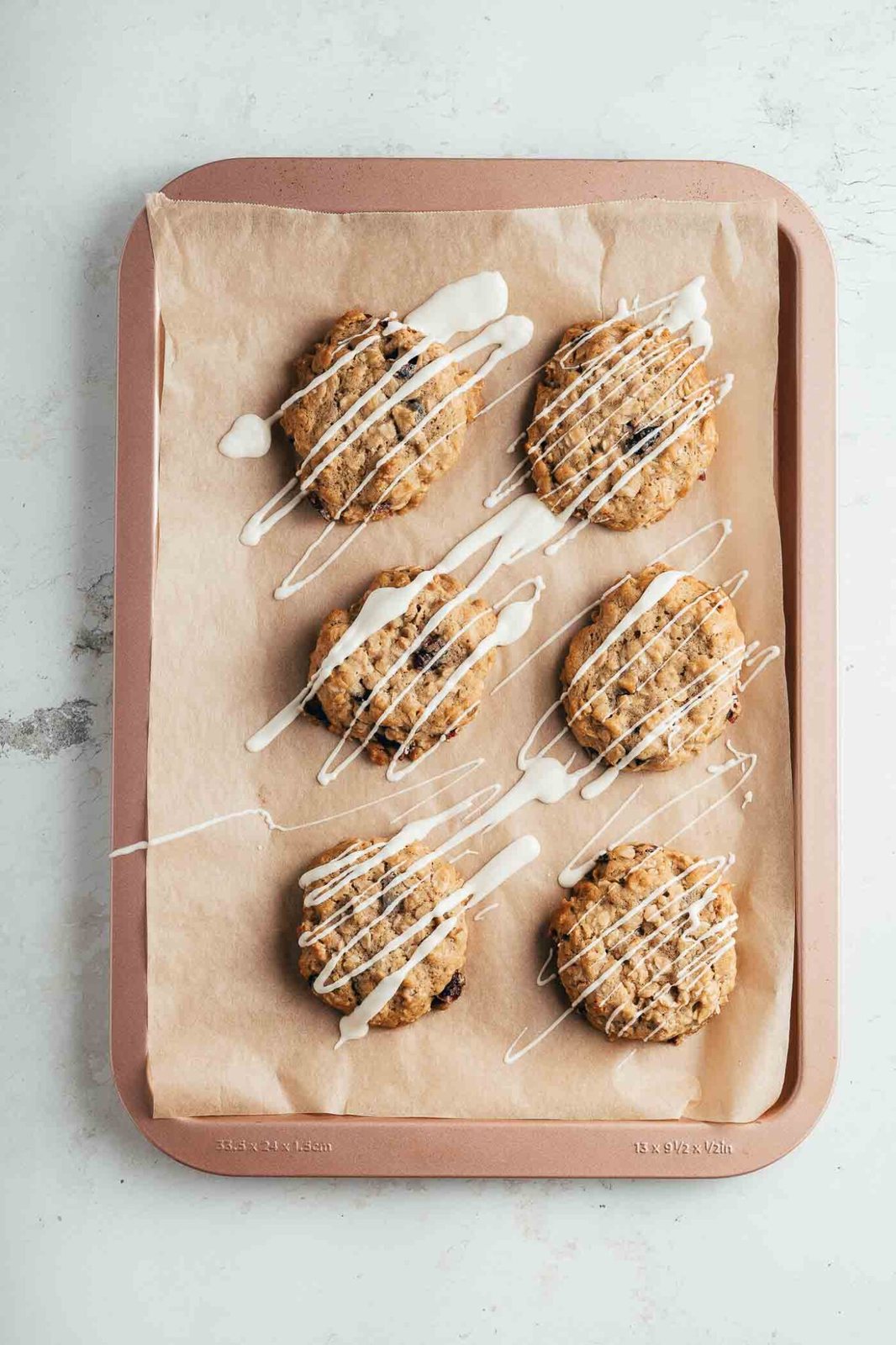 cooked and glazed cookies on a cookie sheet