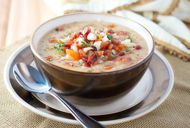 Cauliflower soup in a bowl served with a spoon