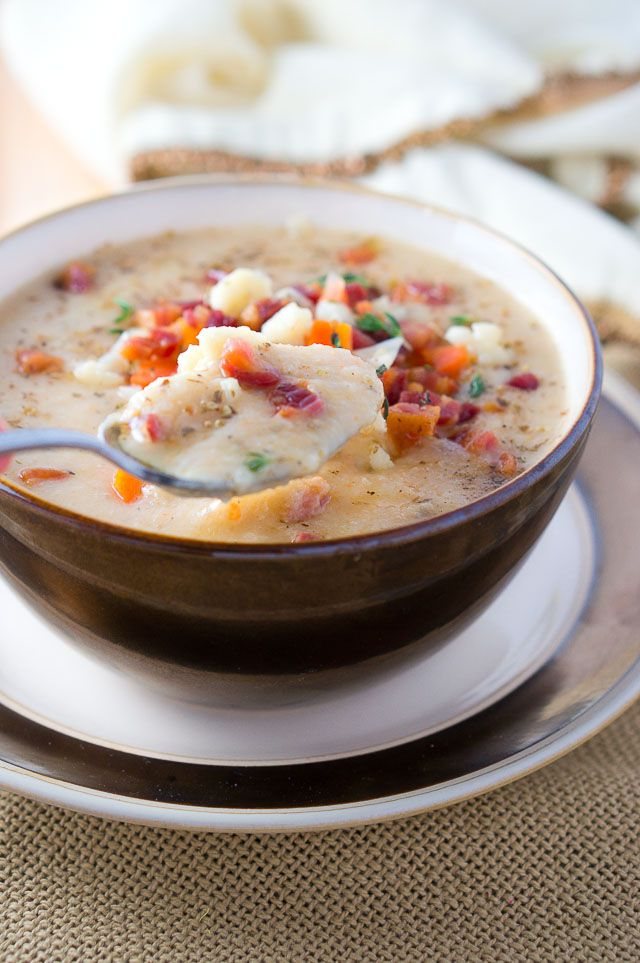 Cauliflower soup in a bowl and on a spoon