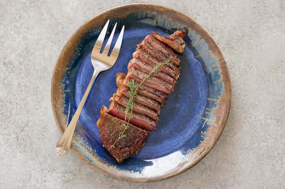 sous vide steak on blue plate