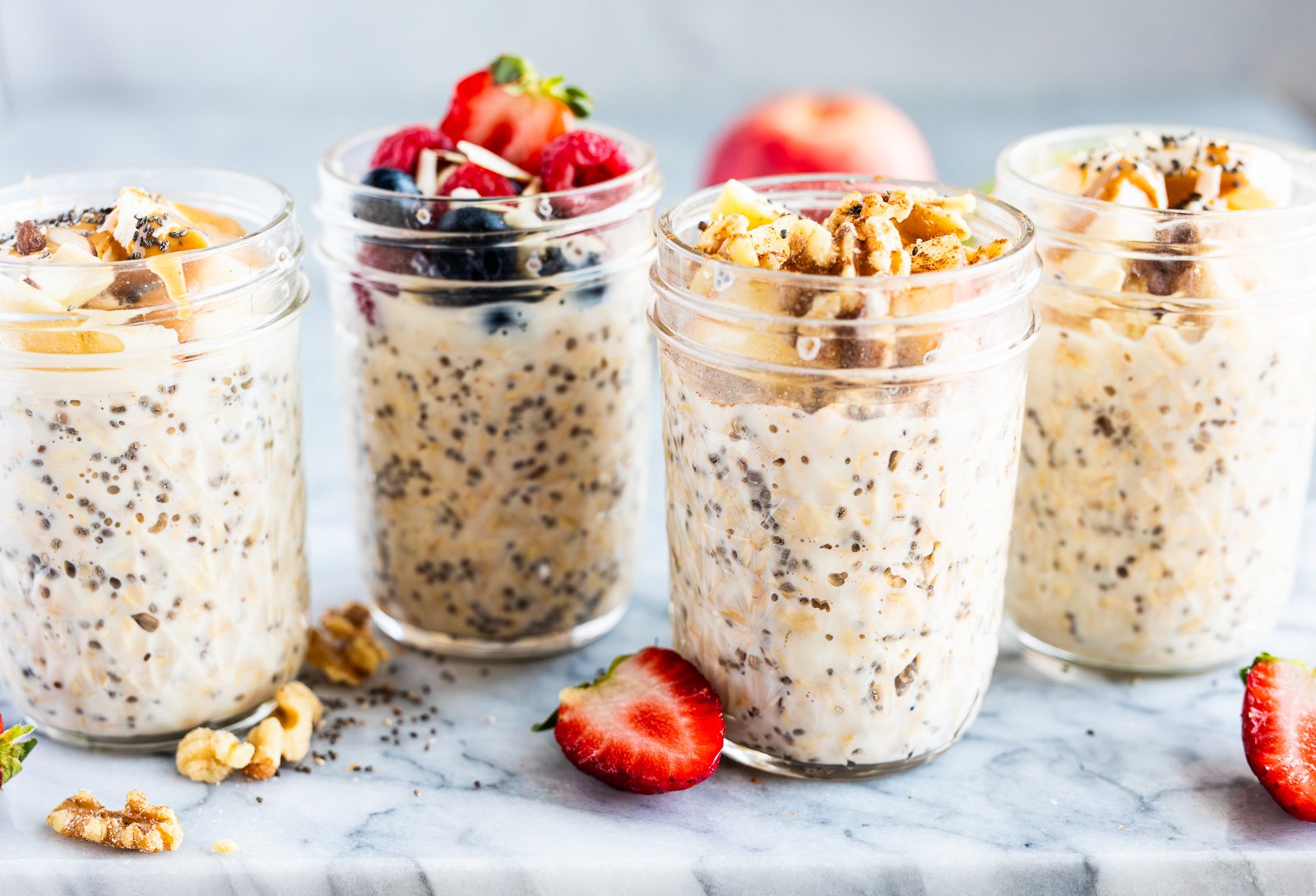 Make-ahead overnight oats in four small jars, a quick and healthy grab-and-go breakfast for busy mornings.