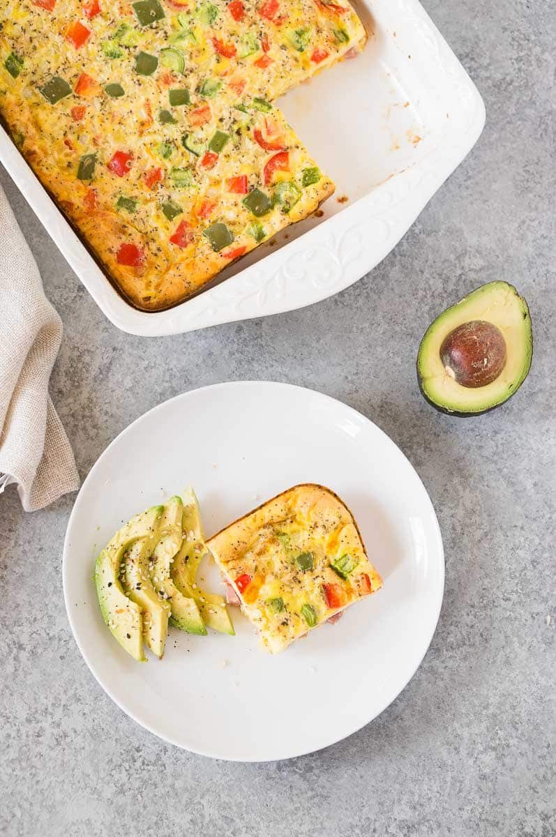 cheesy baked egg casserole with ham and cheese on a plate