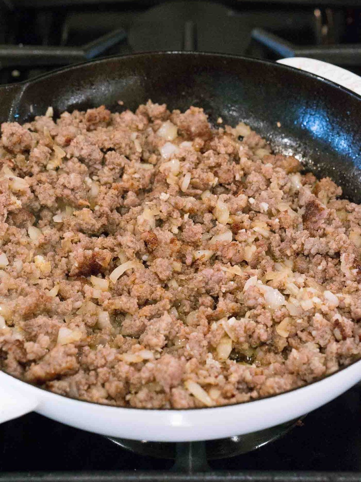 cooking onion and ground meat in a skillet