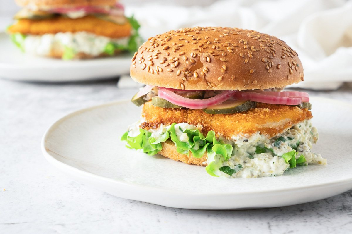 burger with fried fish fillet on a plate