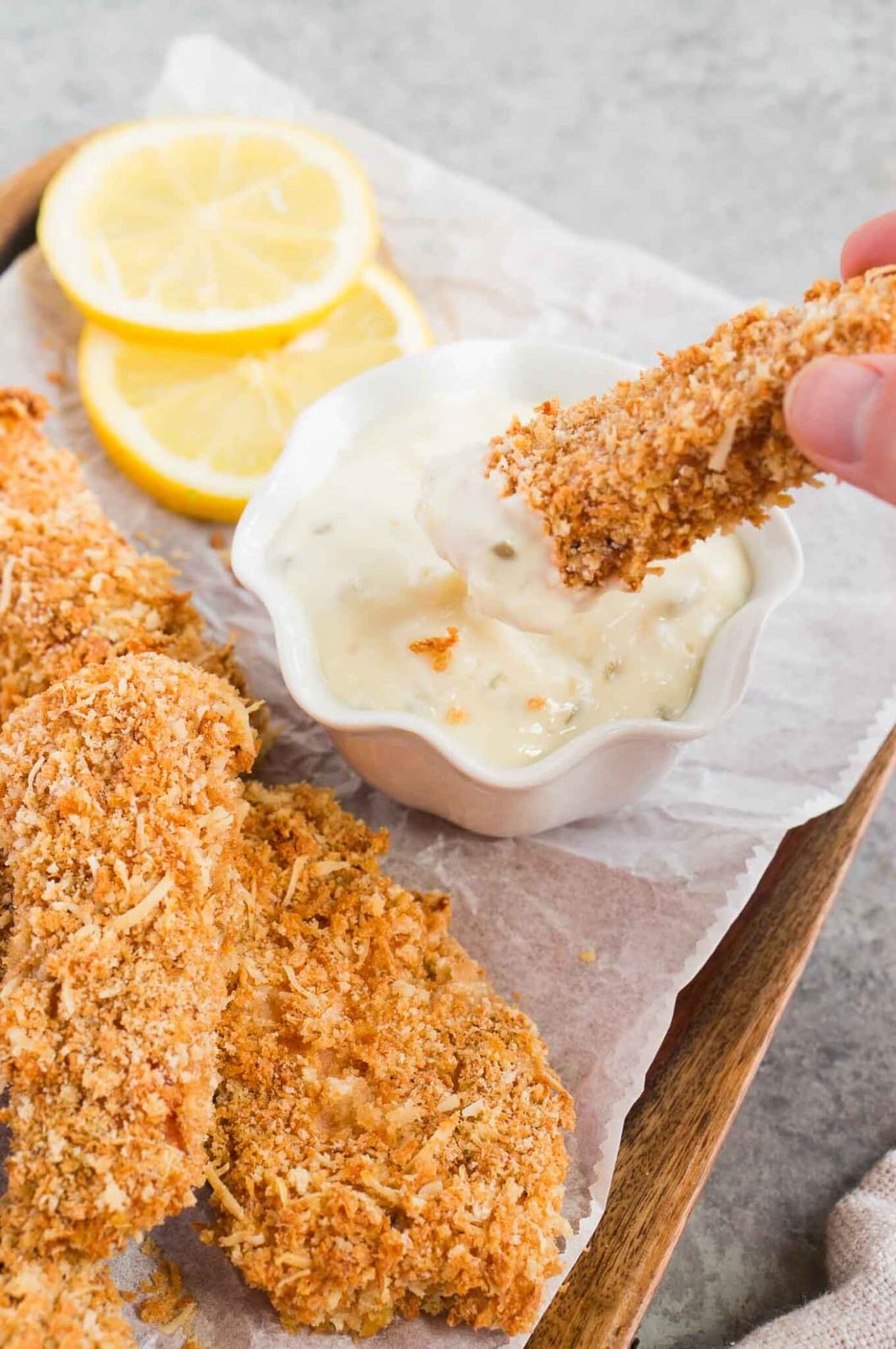dipping fish finger in tartar sauce