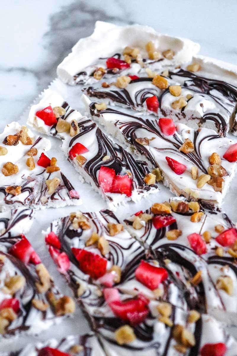 frozen yogurt bark pieces with strawberries and chocolate