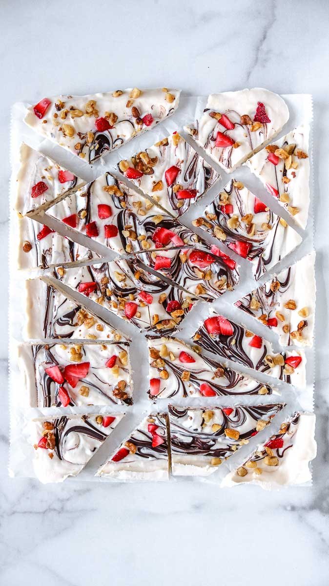 keto yogurt bark topped with strawberries chocolate and walnuts