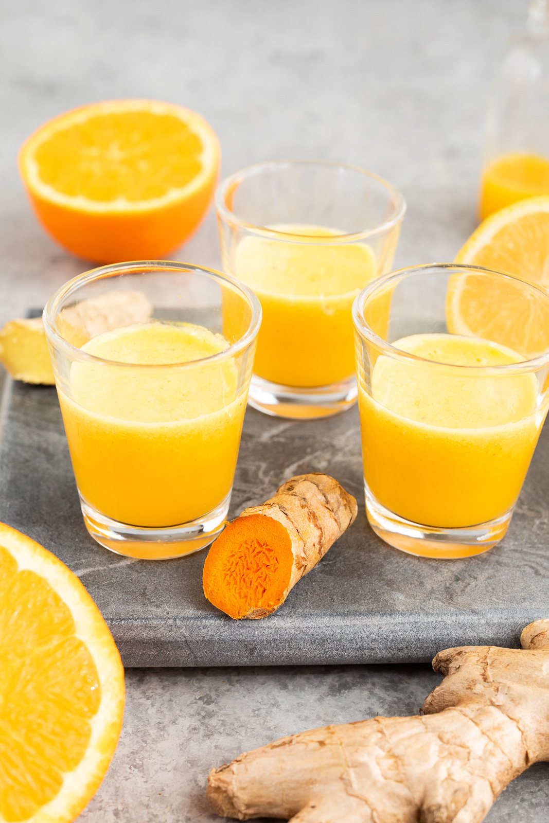 Ginger Turmeric Citrus Juice Shots in glass shots