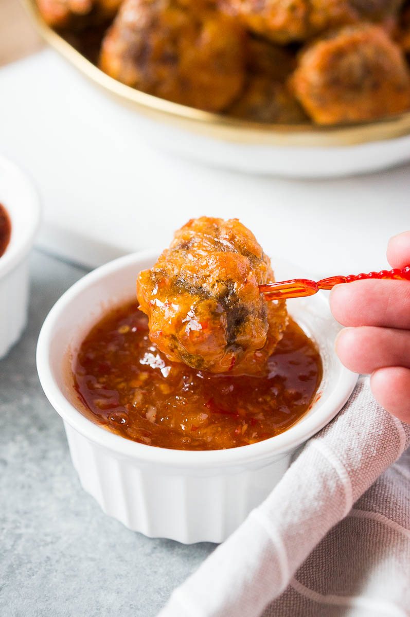 dipping sausage ball in a apricot chili dip